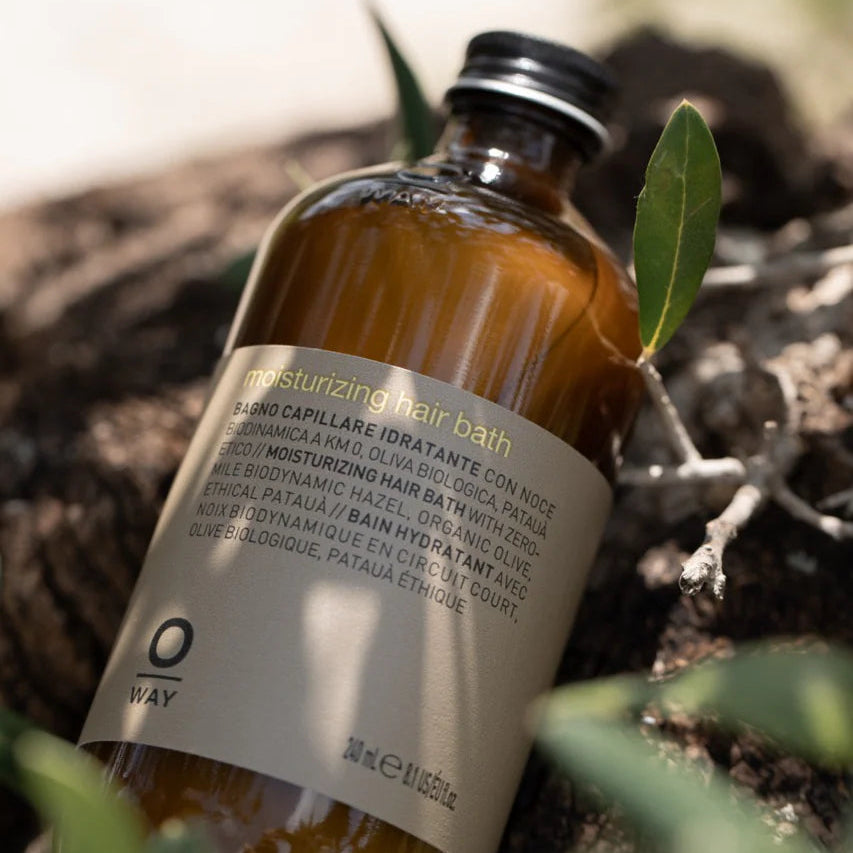Bottle of hair bath with a label on a natural background